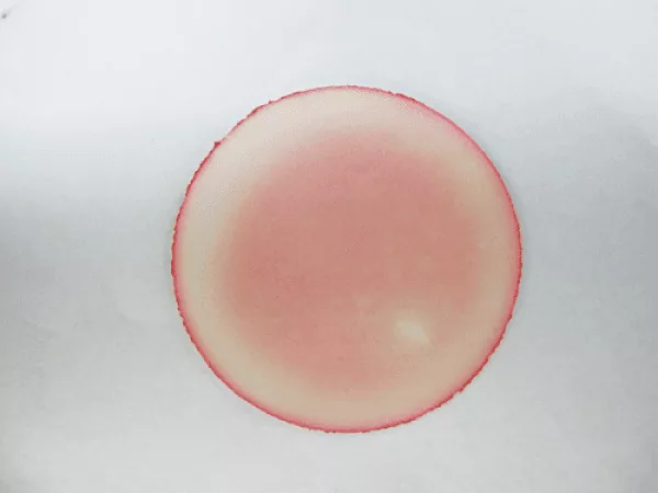 Vinyl treated with competitor antimicrobial, stained pink